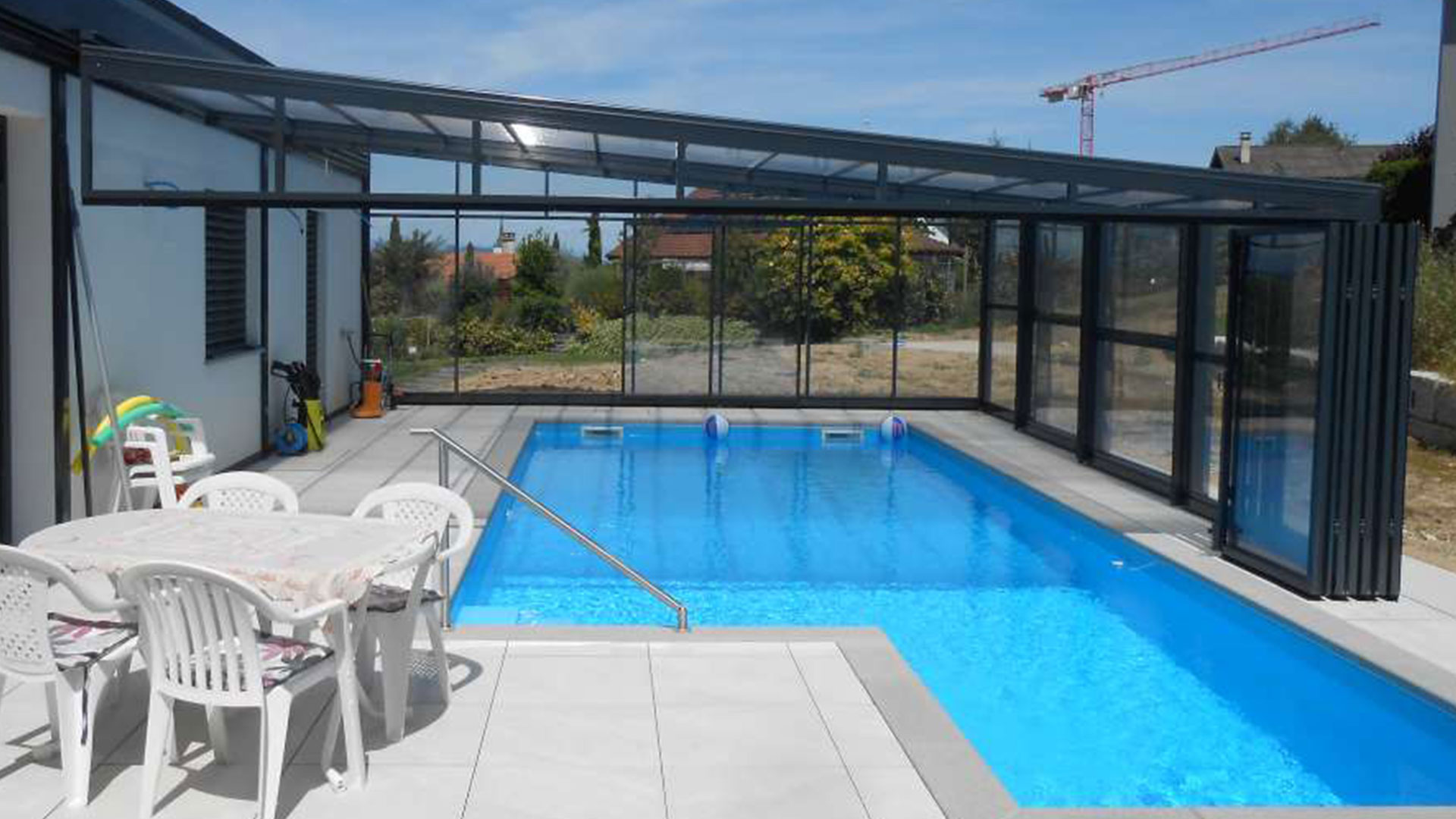 Abri de piscine mural Europa adossé à maison moderne Genève